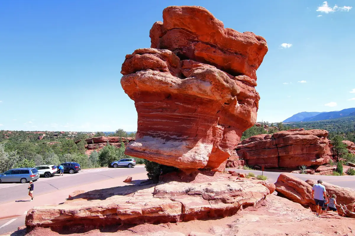 Balanced Rock beside the park road with visitors at its base